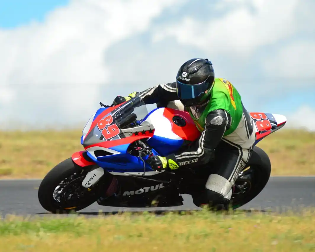Motorcycle racer leaning into a turn.
